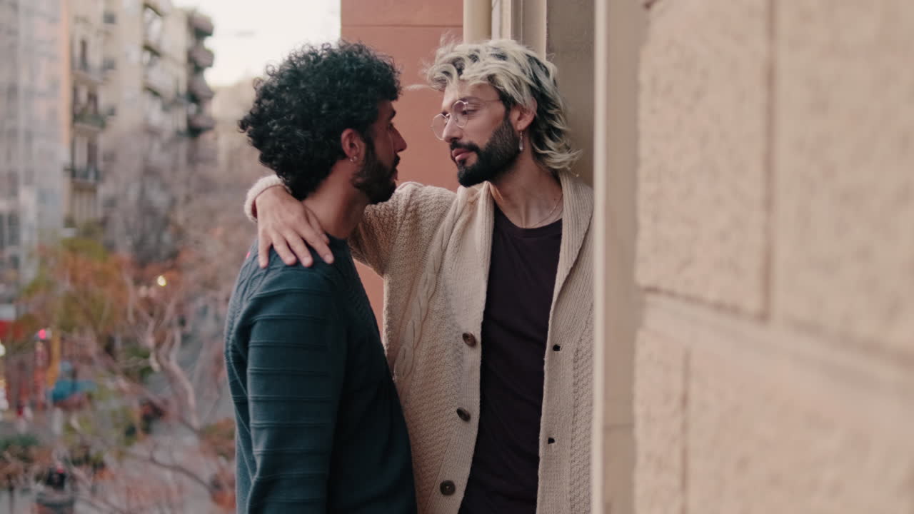 Gay Couple Kissing on Balcony at Home