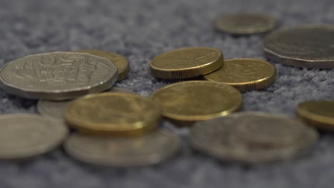 coins falling onto the carpet, extreme close up of australian coins, macro 4k