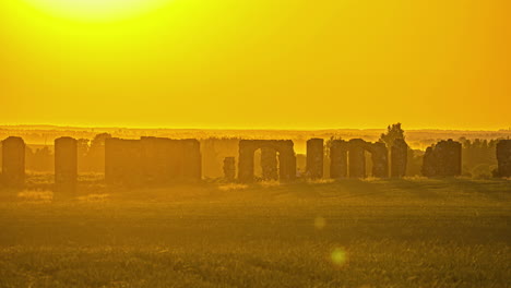 time lapse of ruins of an old castle in a field at hot yellow sunset