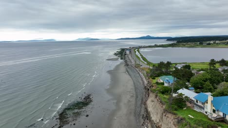 aerial view showing the end of the bluff on whidbey island's west beach with the ocean and the san juan islands off in the distance