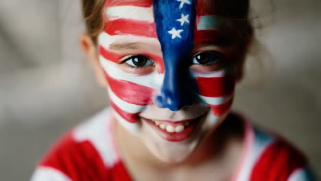 child with american flag face paint