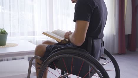 young physically handicapped person reading a book at home.