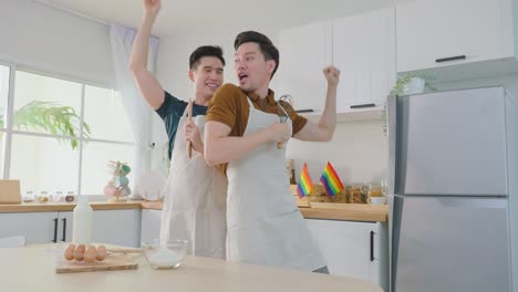 happy couple cooking and dancing in the kitchen