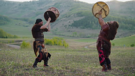 folk rock band dances with tambourines in mountain valley