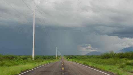 road leading into the distance with monsoon rain and storm clouds, time-lapse