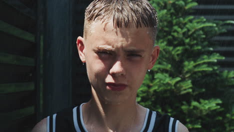 teenage boy wet from rain outdoors