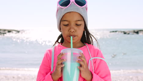 Girl,-beach-and-drink-milkshake