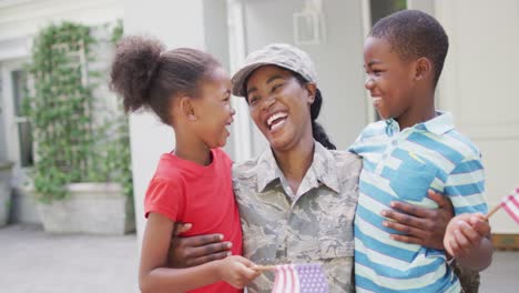 Animation-of-happy-african-american-soldier-mother-and-children-hugging-and-embracing