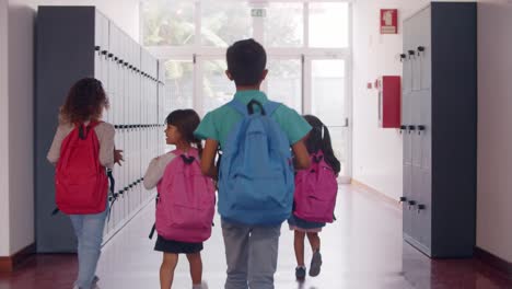 diverse group of schoolchildren of different ages walking calmly to the exit