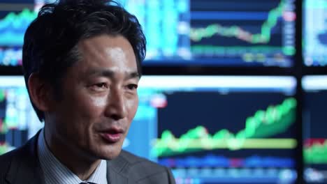 financial expert discusses market trends and analysis amidst dynamic stock charts and data visualization in a professional setting