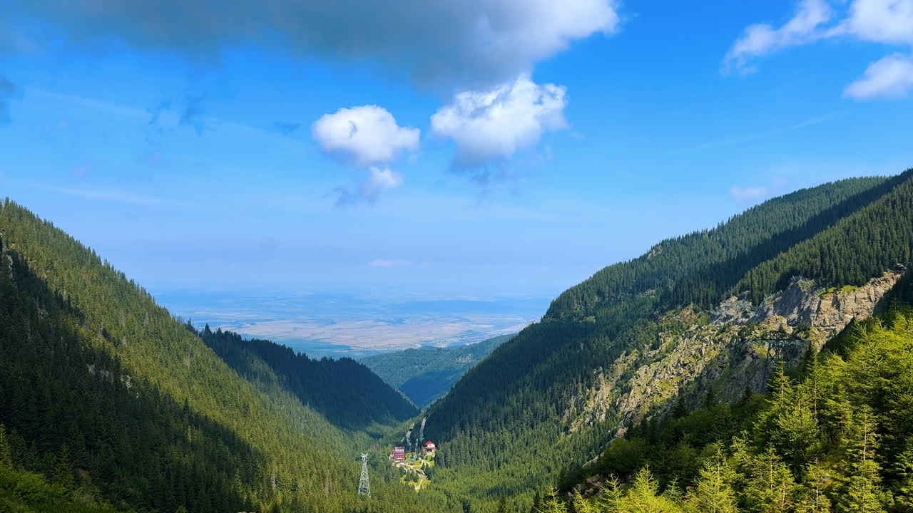 Waterfall near the Transfagarasan road. Drone view of a waterfall cascading down the green slopes of the Carpathian Mountains near the Transfagarasan highway in Romania
