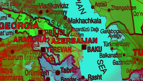 a detailed political map showcasing the caucasus region, including georgia, armenia, azerbaijan, and their neighboring countries, along with major cities and the caspian sea
