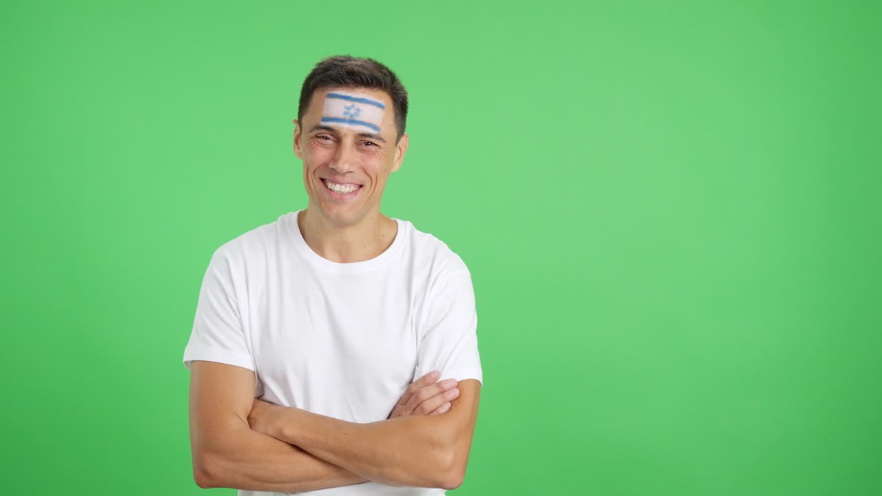Man standing with israeli flag painted on face smiling