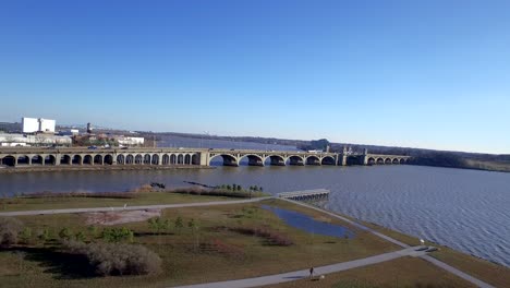 soaring above park and over historic bridge and windy river