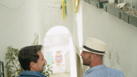 back view of homosexul male couple going down stairs in street