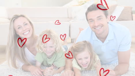 animation of red hearts over happy caucasian parents with children at home