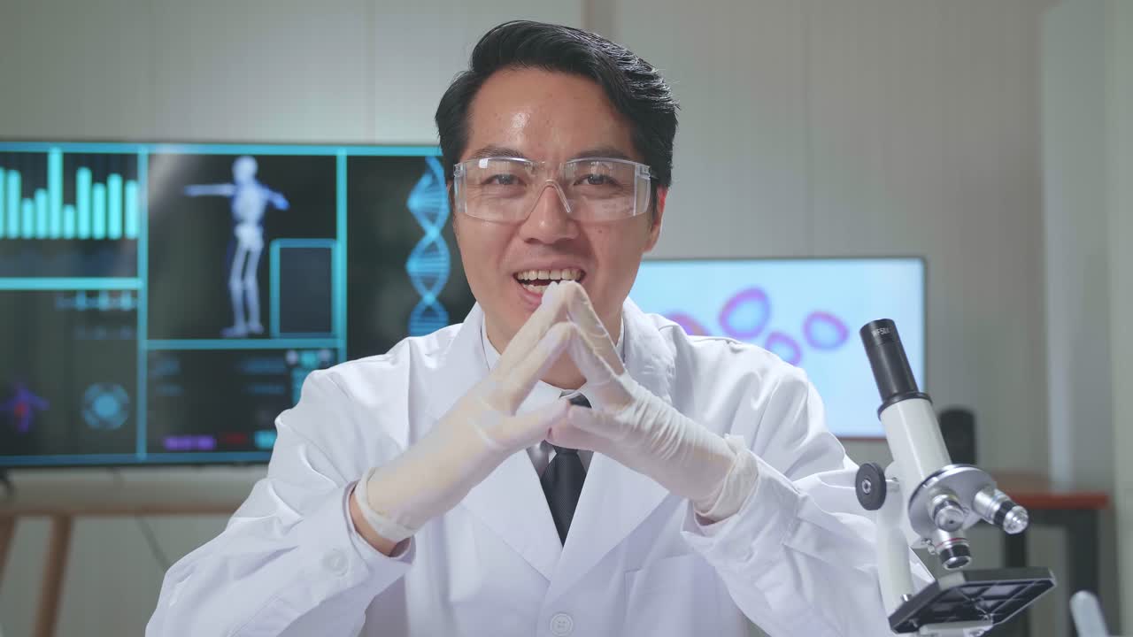 Asian Scientist Researching In The Laboratory With A Microscope And Speaking To The Camera
