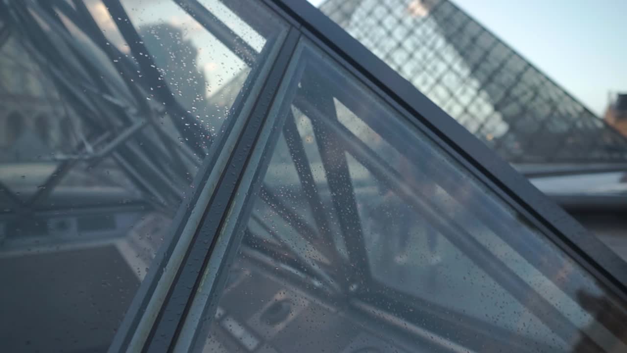 A slow reveal of the Louvre Pyramid in Paris France.  Above the Louvre museum.