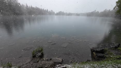 Snow-gently-fall-on-Mystical-Lake-with-Crystal-Clear-Water-surrounded-by-Forest