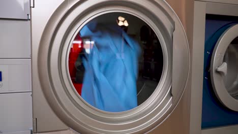 industrial dryer machine working close-up of drying clothes in drying machine close up