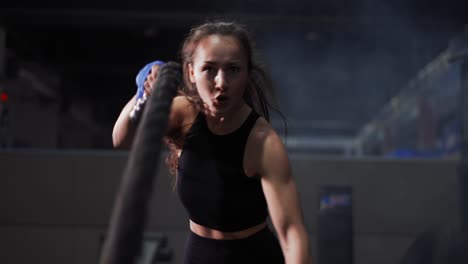 Young-Woman-Doing-Some-Crossfit-Exercises-With-A-Rope-Indoor,-Front-View