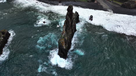 Aerial-view-rising-around-the-Ilheus-da-Rib,-cloudy-day-in-Ribeira-da-Janela,-Madeira