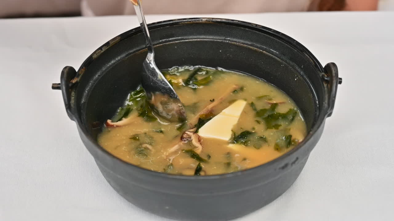 Japanese seaweed miso soup with tofu cheese, slow motion stir
