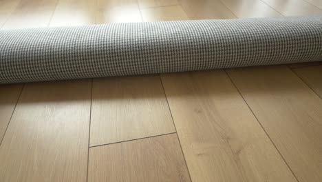 rolled carpet on wood flooring