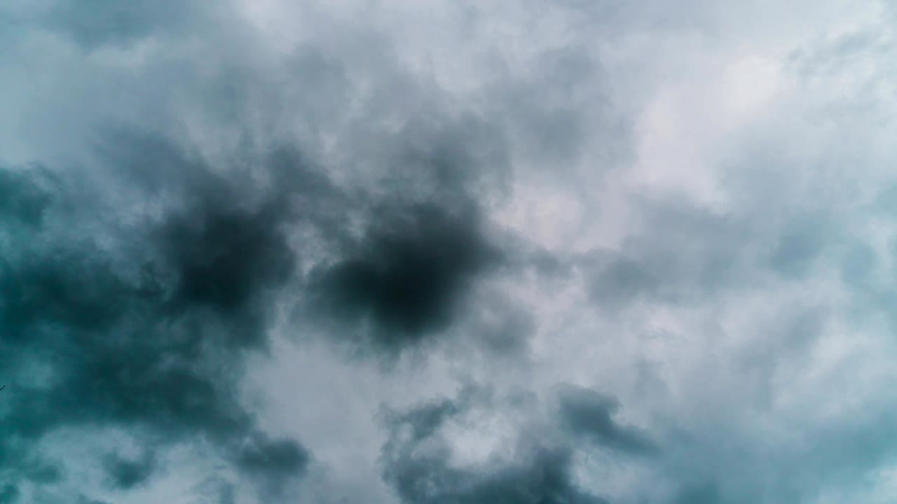 A very dark rainy clouds move rapidly across the sky time lapse