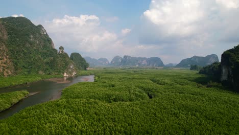 Drone-flying-over-Ao-Thalane-mangroves-and-river-in-Krabi-Thailand-on-a-sunny-day-overlooking-the-mountains