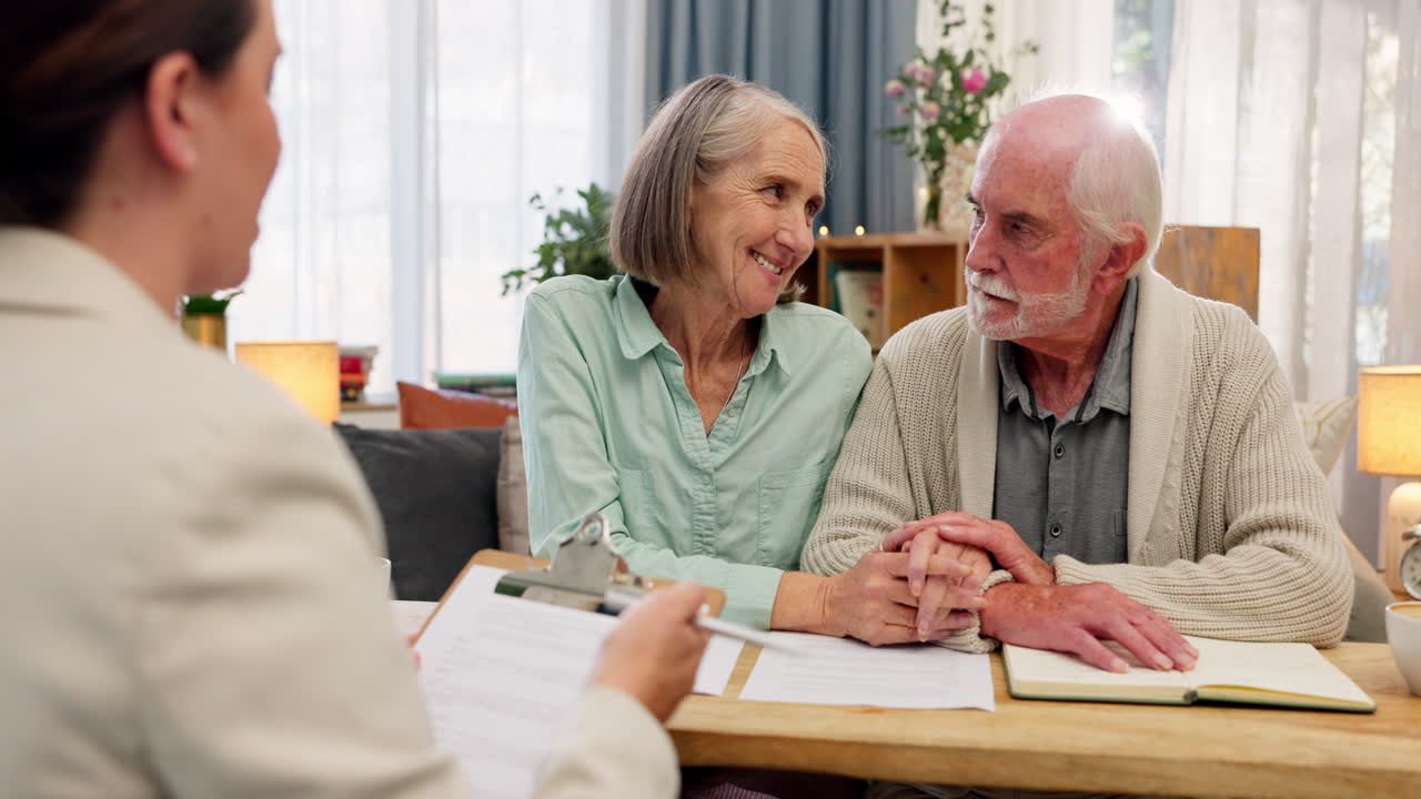 Elderly couple meeting with a financial advisor in their home