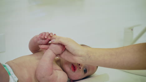 doctor examining baby boy. close up of small baby visiting doctor