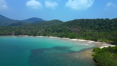 ong beach at koh chang island showing turquoise water and green rainforest in trat province, thailand. lovely aerial view flight panorama orbit drone
