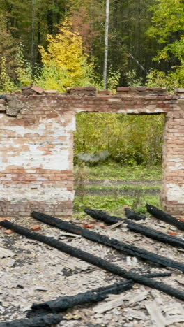 burnt building in forest with people on quad bike