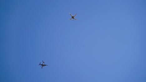 drones flying in sky. drone flying over the blue sky background