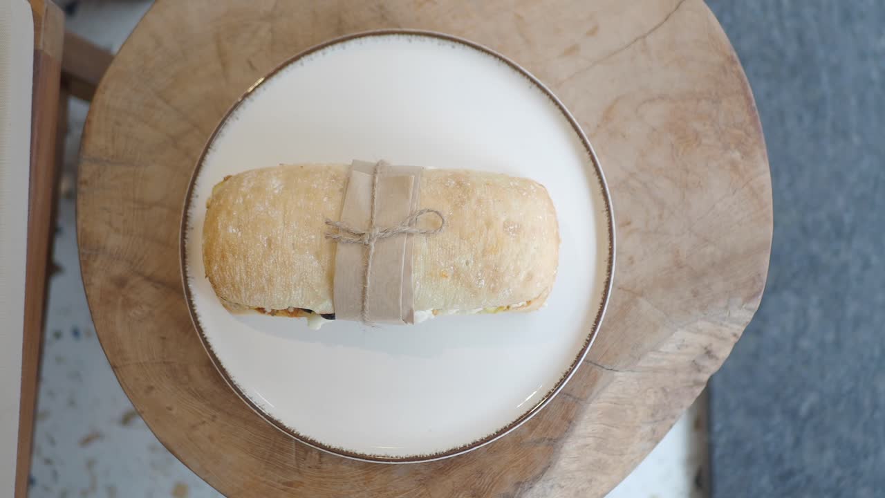 Appetizing Panini Sandwich Wrapped on a White Plate