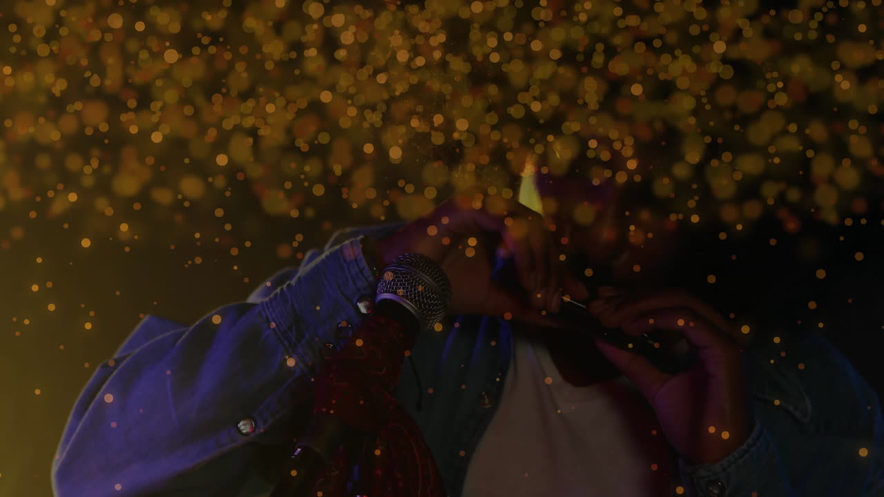 Male musician performing harmonica on stage, showcasing animated golden bokeh for music marketing