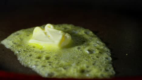 macro view of butter melting texture with sizzling foam, hot frying pan closeup