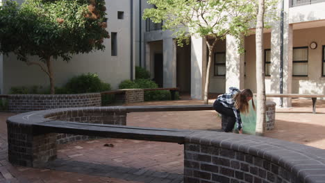 cleaning school courtyard, young girl holding trash bag under tree, maintaining cleanliness