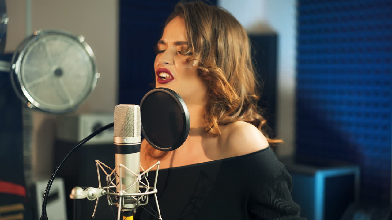 Beautiful young singer who recorded a song in a professional recording studio. Female vocal