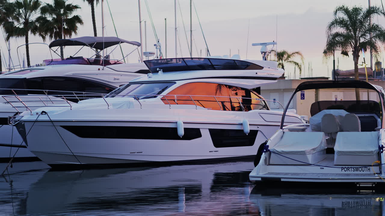 Antibes, France - May 8, 2025: Multiple white boats docked in the Port Vauban at sunset