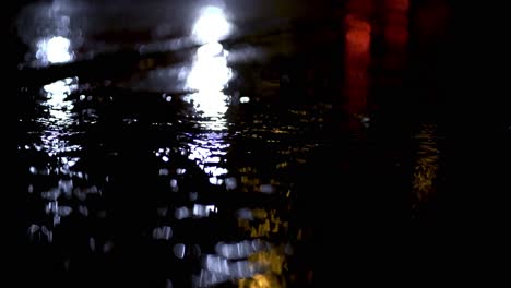 Blue-lights-of-emergency-vehicle-reflecting-from-wet-ground-during-rainstorm-in-Munich