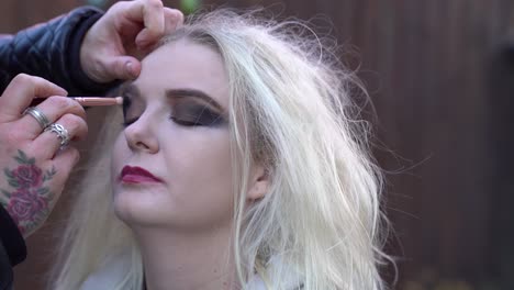 pretty blonde model having her make up applied