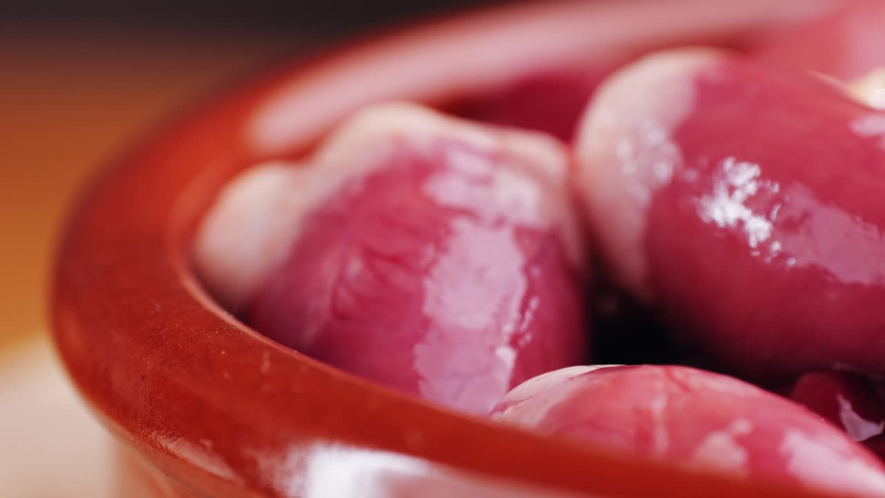 Raw Chicken Hearts in a Bowl
