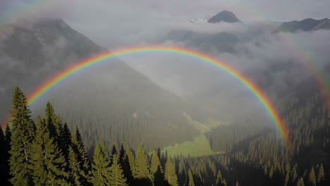 double rainbow over mountain valley