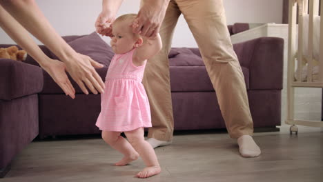 baby first steps. baby learning to walk. family support little kid