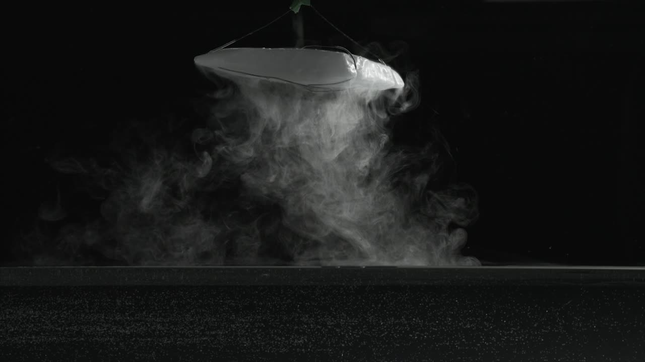 Slow motion dry ice fog-vapor floating on surface of water and bubbling in water. For use with visual effects and-or texturing and design.
