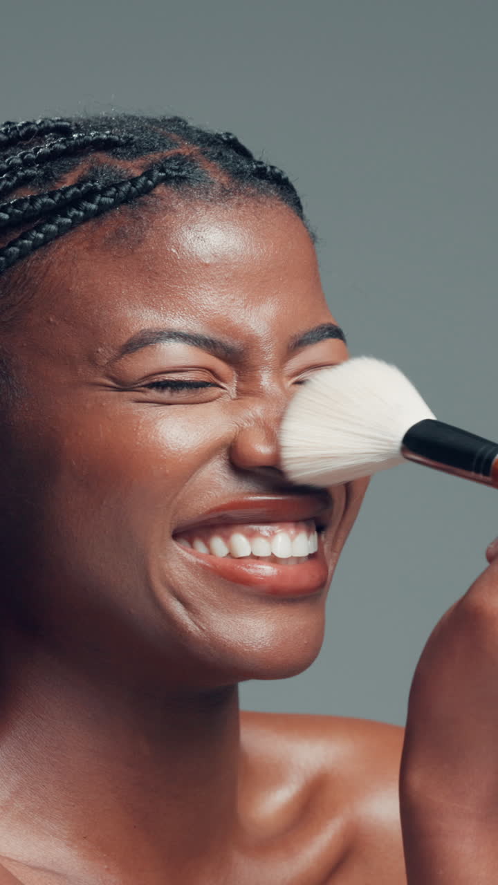 Joyful Black Woman Smiling as Makeup Brush Touches Her Nose