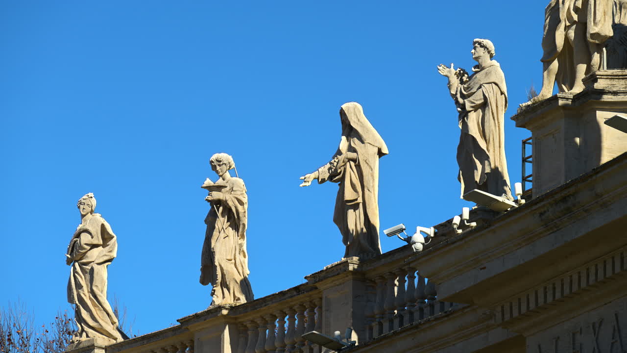 Statues on the Facade of St. Peter's Basilica on the blue sky background, in St. Peter's Square, Vatican City, Rome, Italy