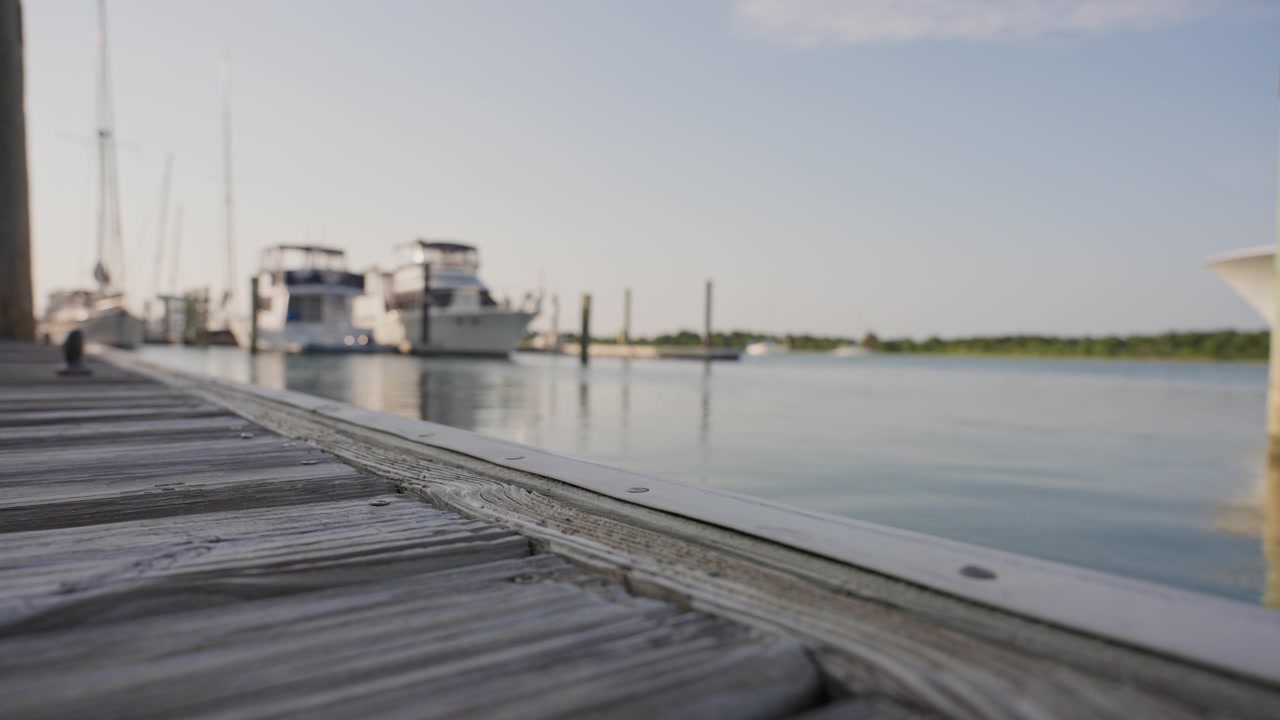 The downtown Beaufort waterfront features wooden docks, calm water, and recreational boats in a picturesque coastal setting beside Taylor’s Creek.